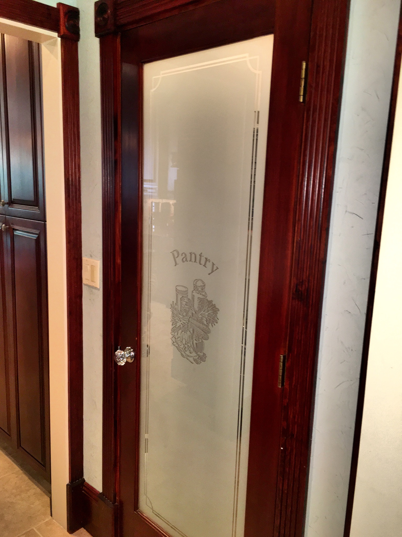 Custom pantry door with etched glass, fluted casing and rosette blocks